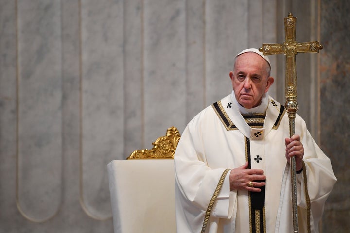 Pope Francis attends Easter Sunday Mass, inside an empty St. Peter's Basilica at the Vatican, Sunday, April 12, 2020. 