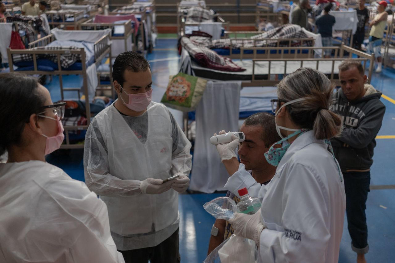Patients undergo exams conducted by health care workers with Doctors Without Borders.