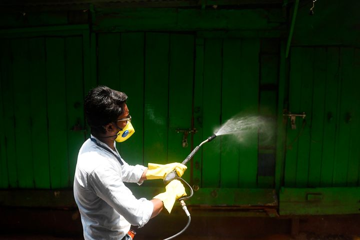 A municipal worker sprays disinfectant as a preventive measure against the COVID-19 coronavirus in Kolkata on April 12, 2020.