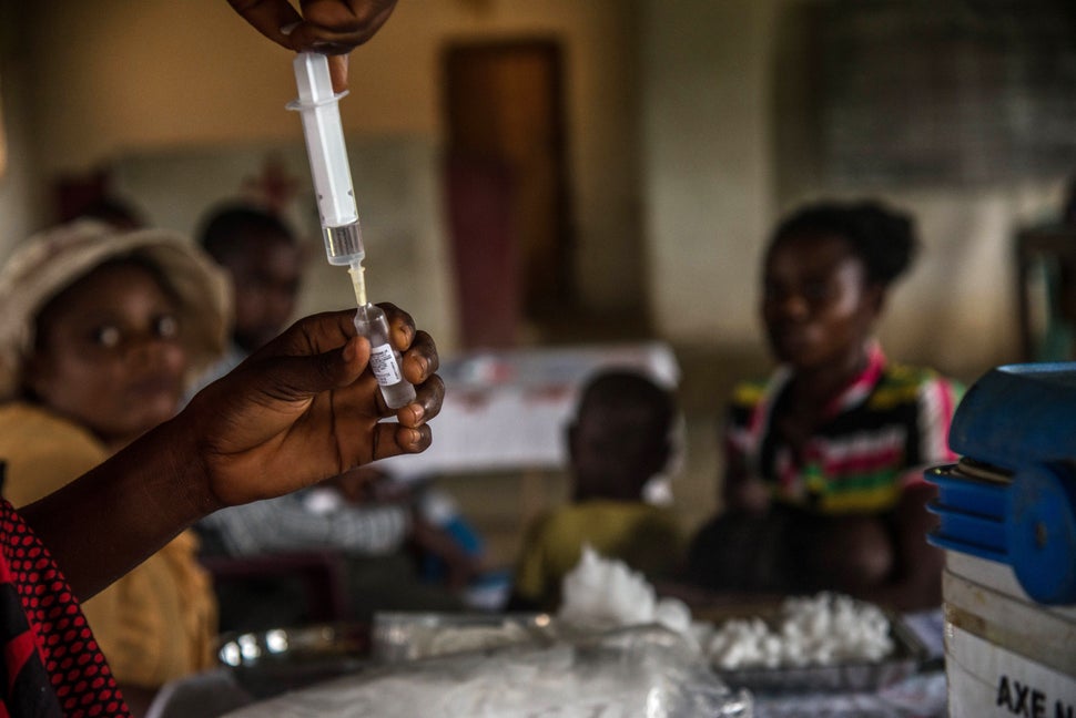 Children wait to be registered before a measles vaccination at a center in Mbata-Siala, near Seke Banza, in the Democrat