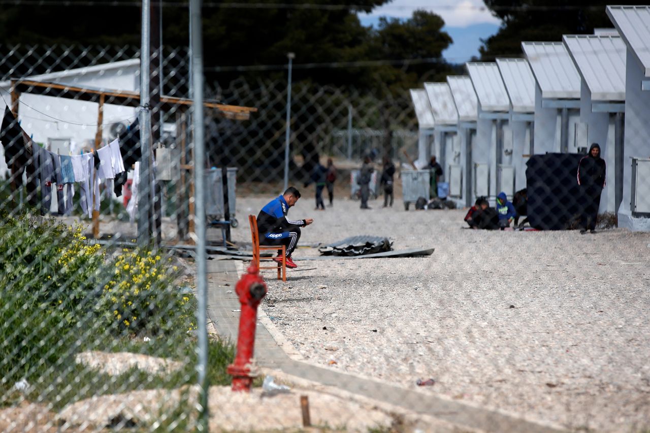 People gather outside their container houses during a quarantine against coronavirus at a refugee camp in Ritsona about 50 miles north of Athens, on April 2. Greek authorities have placed the refugee camp under 14 days' quarantine after 23 of its residents tested positive for the COVID-19.