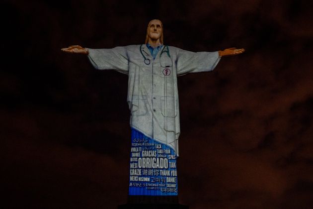 View of the illuminated statue of Christ the Redeemer that reads 