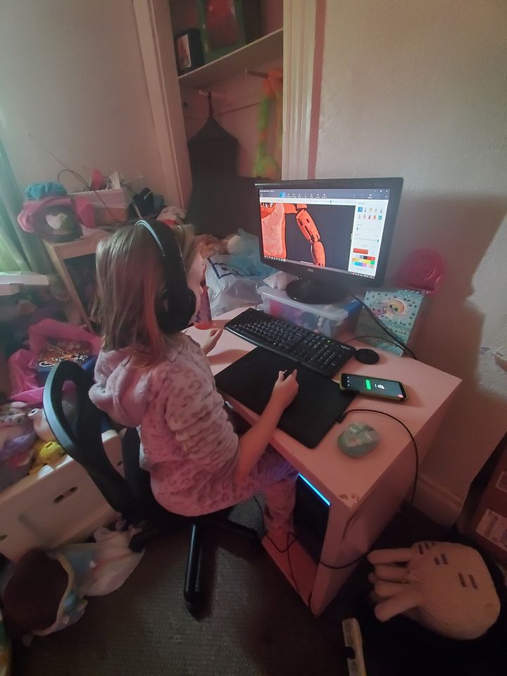 Moreau shared a photo of her nearly 9-year-old daughter at the computer, for size comparison.