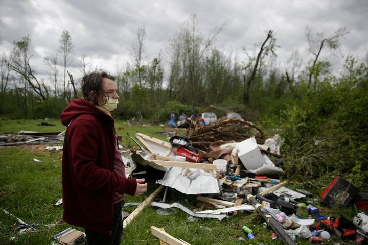 Michael Berhm, 16, stands next to his destroyed mobile home after a tornado hit, Monday, April 13, 2020, in Chatsworth, Ga. (AP Photo/Brynn Anderson)