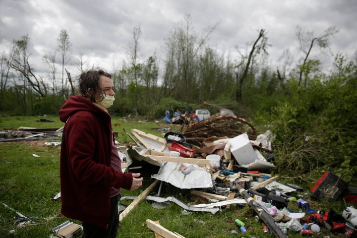 Michael Berhm, 16, stands next to his destroyed mobile home after a tornado hit, Monday, April 13, 2020, in Chatsworth, Ga. (