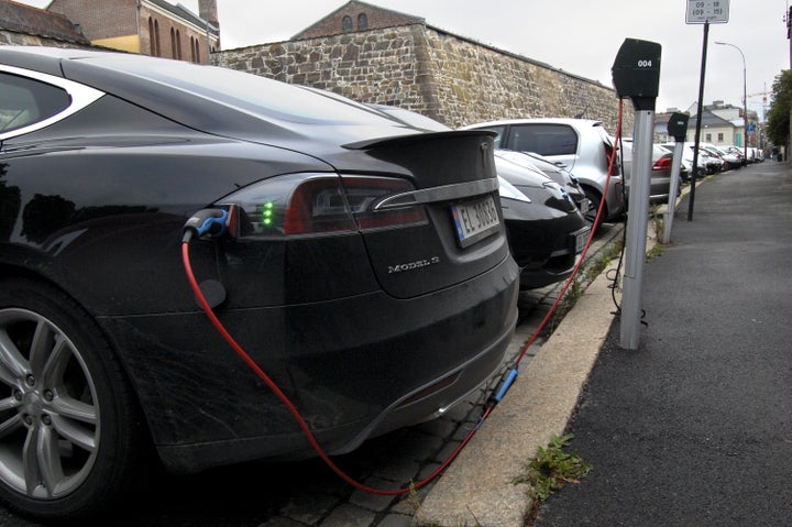 Cars in free parking spaces for electric vehicles get charged in Oslo.