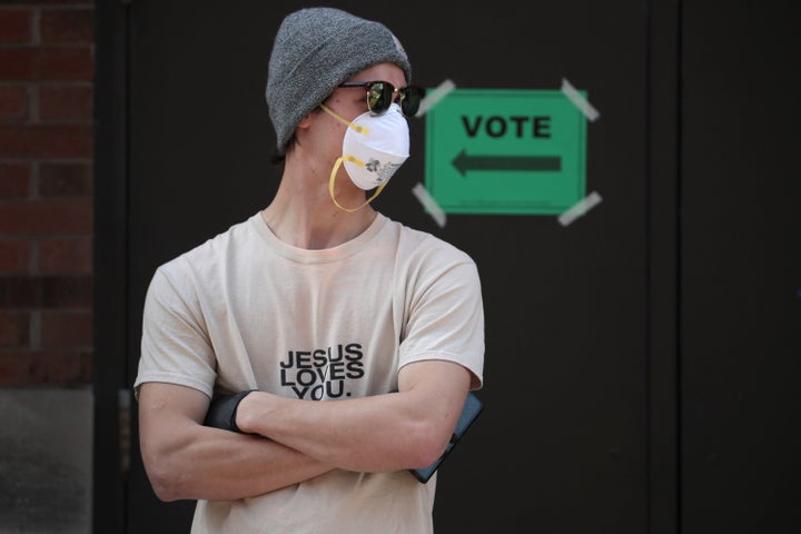 Some waited more than two hours to vote April 7 at a school in Milwaukee, one of the few polling places open in the city after most were consolidated due to a shortage of poll workers fearful of contracting COVID-19.