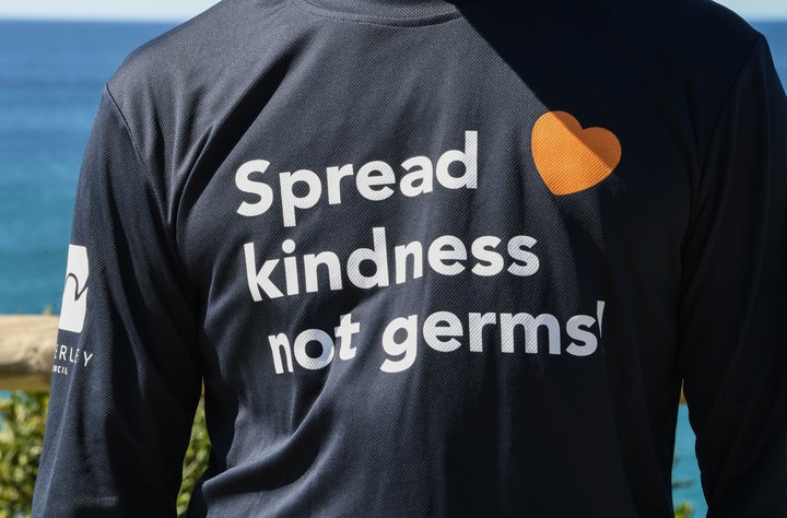 Council ambassadors wear t-shirts with clear messages to the community on the Bondi to Bronte coastal walk on April 11, 2020 in Sydney, Australia.