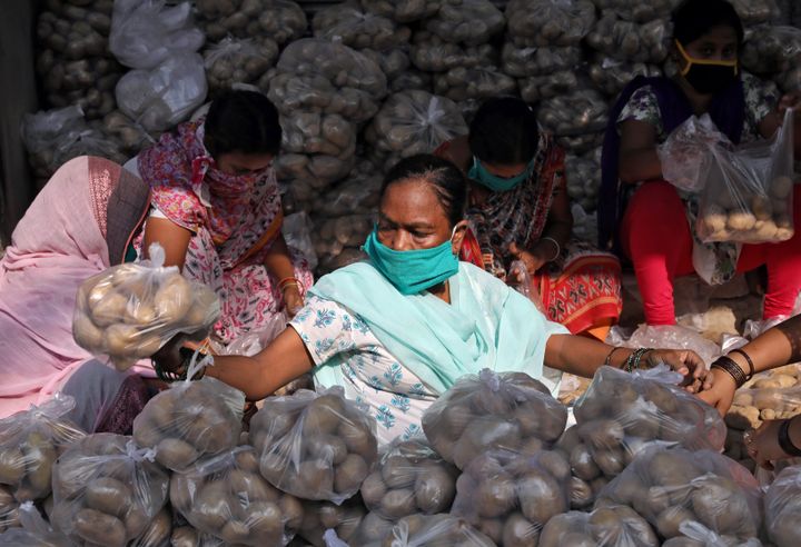 Volunteers pack potatoes to be distributed among poor people at a residential area in Kolkata during the 21-day nationwide lockdown in light of the coronavirus outbreak. 