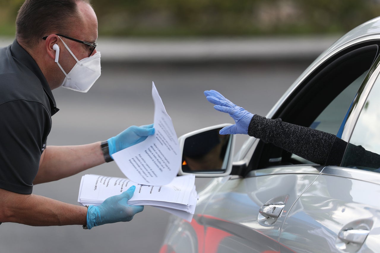 Eddie Rodriguez, who works for the city of Hialeah, Florida, hands out unemployment applications on April 08, 2020. 