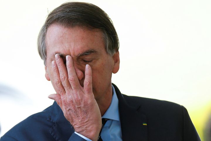Brazil's President Jair Bolsonaro reacts while meeting supporters as he leaves Alvorada Palace, amid the coronavirus disease (COVID-19) outbreak, in Brasilia, Brazil, April 9, 2020.