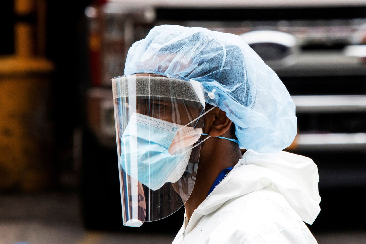 A person wearing a PPE suit exits the Elmhurst Hospital center as the outbreak of the coronavirus continues in Queens in New York, April 5, 2020.