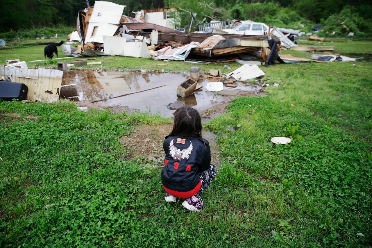 Sky Kriner, 5, looks on after a tornado hit in Chatsworth, Georgia. 