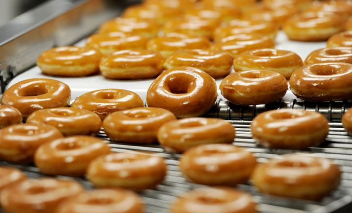 Hot doughnuts move along a conveyor belt at a Krispy Kreme location in Maine.