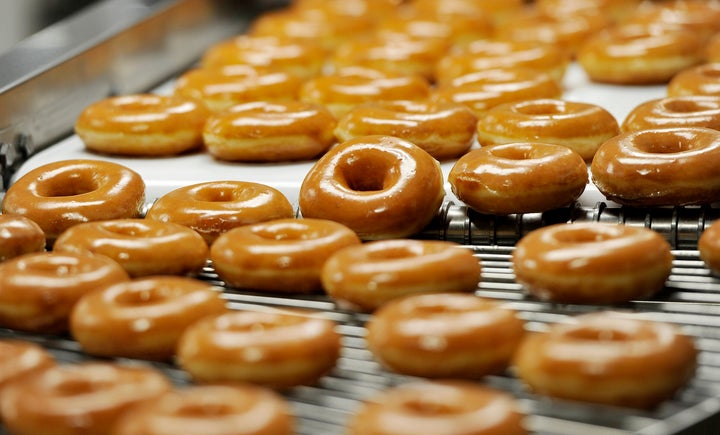 Hot doughnuts move along a conveyor belt at a Krispy Kreme location in Maine.