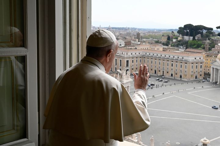 Pope Francis delivering a blessing from the window of his private library overlooking an empty St. Peter's Square on Monday. 