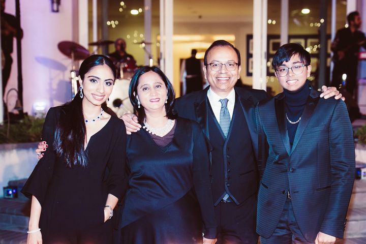 Malvika Sheth (left) with her parents (centre) and brother (right)