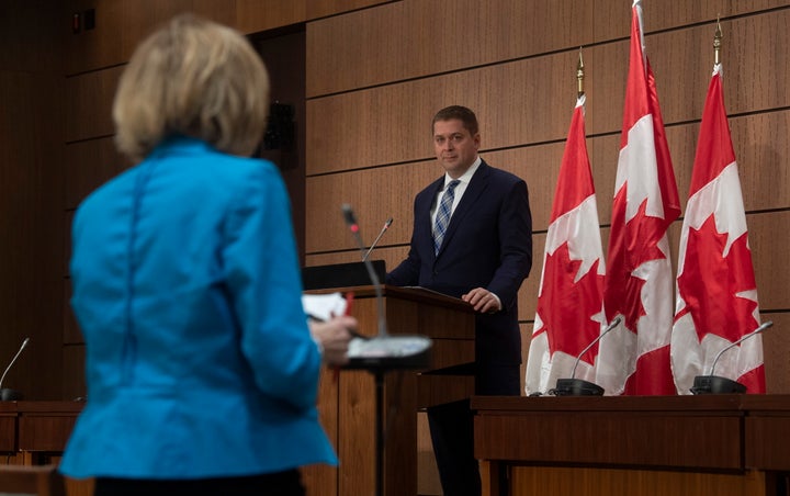Conservative Leader Andrew Scheer listens as a reporter asks a question during a news conference in Ottawa on April 14, 2020.