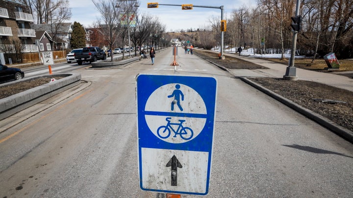 Pedestrians walk along Memorial Drive in Calgary, Alta., on April 9, 2020.