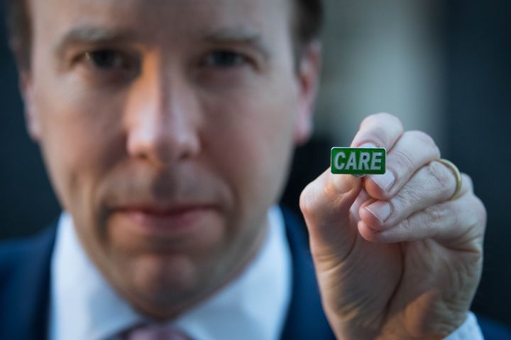 Health secretary Matt Hancock showing the new 'Care' badge, described as a "badge of honour" for social care workers.