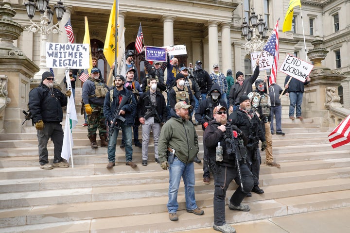 People take part in a protest for "Michiganders Against Excessive Quarantine" at the Michigan State Capitol in Lansing, Michi