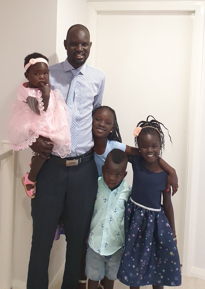 Dor Akech Achiek, shown here with his four children, arrived in Australia as a refugee in 2003.