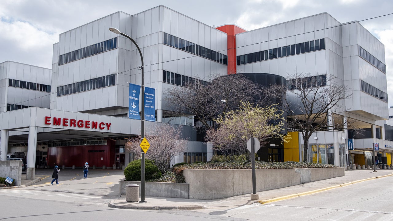 Nurses walk back into the Detroit Medical Center emergency area after a short break on April 10. Emergency room workers do not have enough of the basic protective equipment they need.