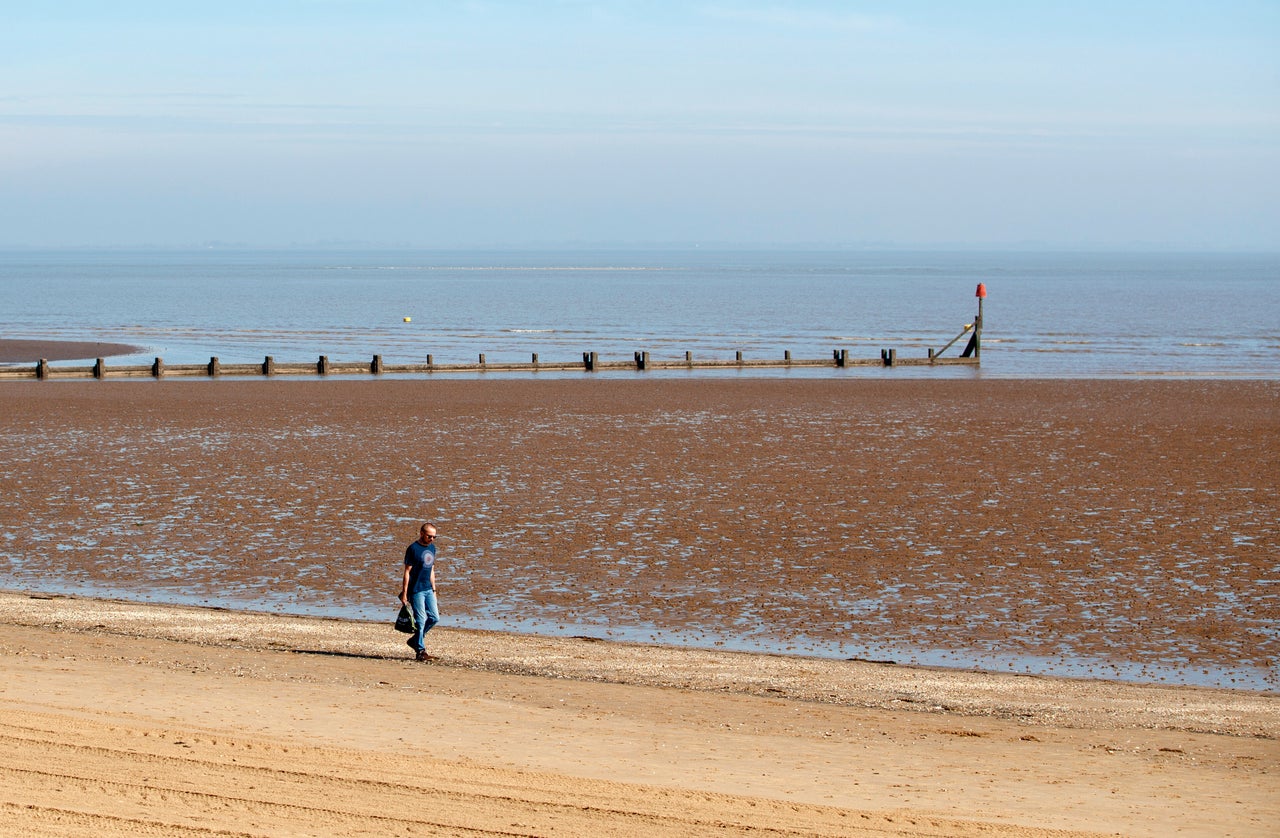 A man walks along the beach in Cleethorpes as the UK continues in lockdown to help curb the spread of the coronavirus. (Photo by Danny Lawson/PA Images via Getty Images)