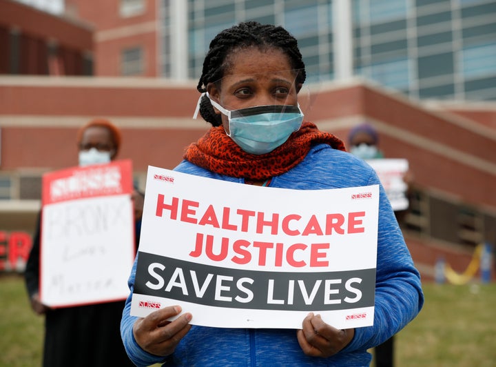 Rehabilitation nurse Edith Ihejirika holds a sign as she participates in a demonstration outside the emergency entrance to Jacobi Medical Center in the Bronx borough of New York on March 28. Nurses at the hospital demonstrated demanding adequate Personal Protective Equipment after Mount Sinai West emergency room nurse Kious Kelly, died after a 10-day bout with the disease.