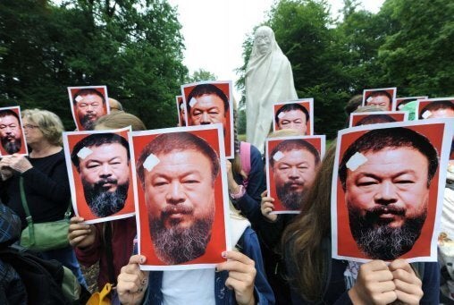 Supporters of Ai in Kassel, Germany, pose with portraits of the dissident artist as part of the project “All for Ai Weiwei.” (Photo by Uwe Zucchi/AFP/Getty)