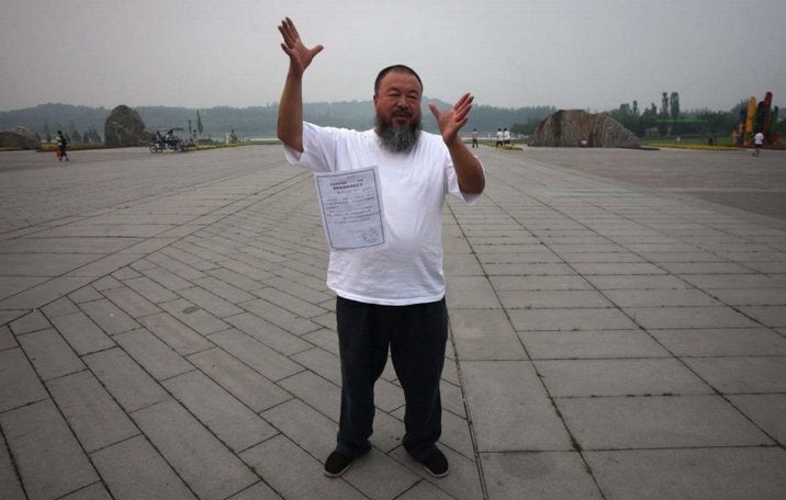 <div class="feature-caption"><em>Ai drops a copy of a government document — informing him of the expiration of his bail term — in a park in Beijing on June 21, 2012. Ai is still unable to leave the country despite the expiration of a one-year bail condition imposed after his release from detention last June. (Photo by Ed Jones/AFP/Getty)</em></div>
