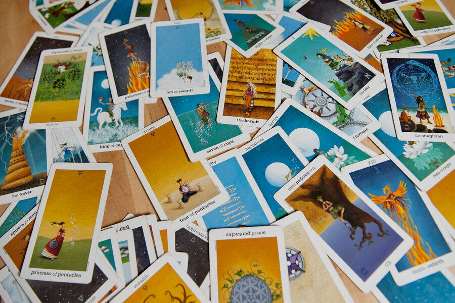 <div class="feature-caption"><em>David alternates between the Sun and Moon and Rider-Waite decks. He usually has a shiva-lingam stone and candles on the table during readings.</em></div>