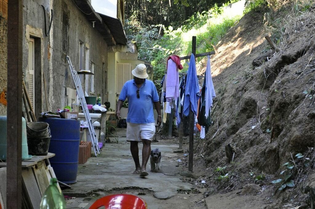 Luiz Pinto, who has been fighting eviction for decades, at home with his dog. (Carolina Ramirez/The Huffington Post)