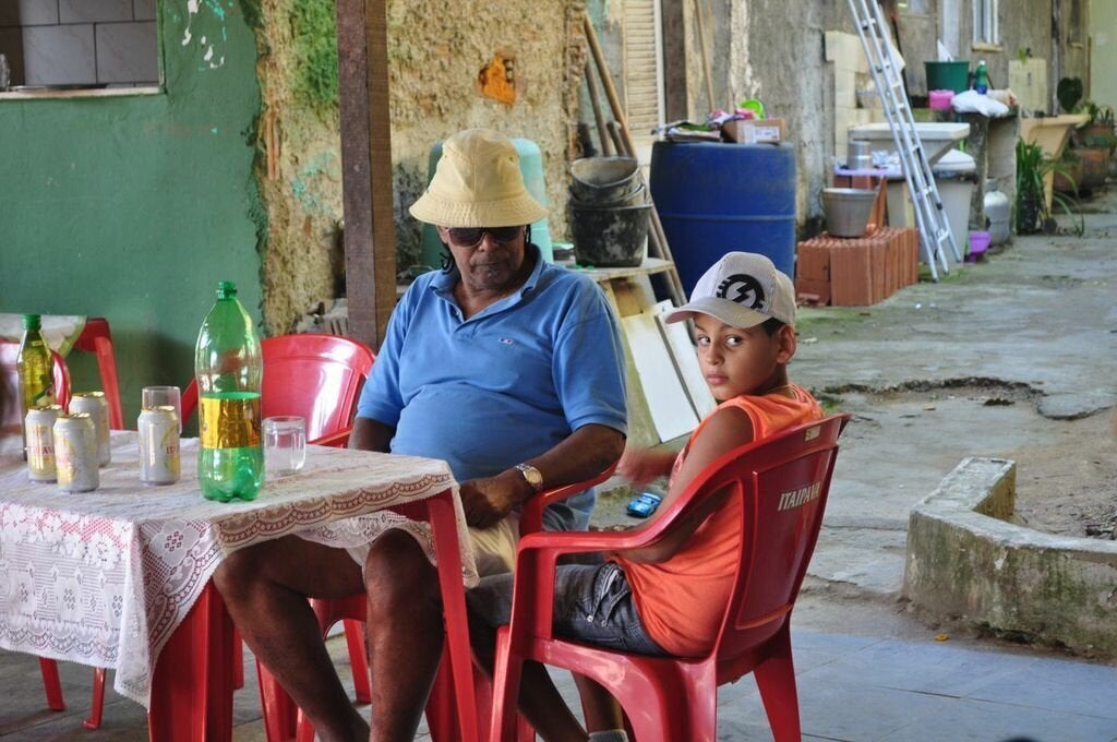 Luiz Pinto and his grandson in the area of their quilombo that once hosted lively parties. Neighbors' complaints have since shut down the events. (Carolina Ramirez/The Huffington Post)