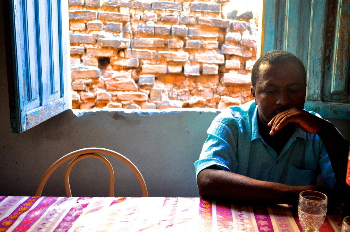 Almir Viera Pereira seated in his mother's kitchen in the town of Barra do Parateca, Brazil. (Carolina Ramirez/The Huffington Post)