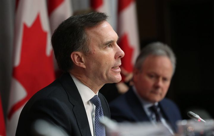 Finance Minister Bill Morneau speaks at a news conference as Bank of Canada governor Stephen Poloz looks on in Ottawa, March 18, 2020.