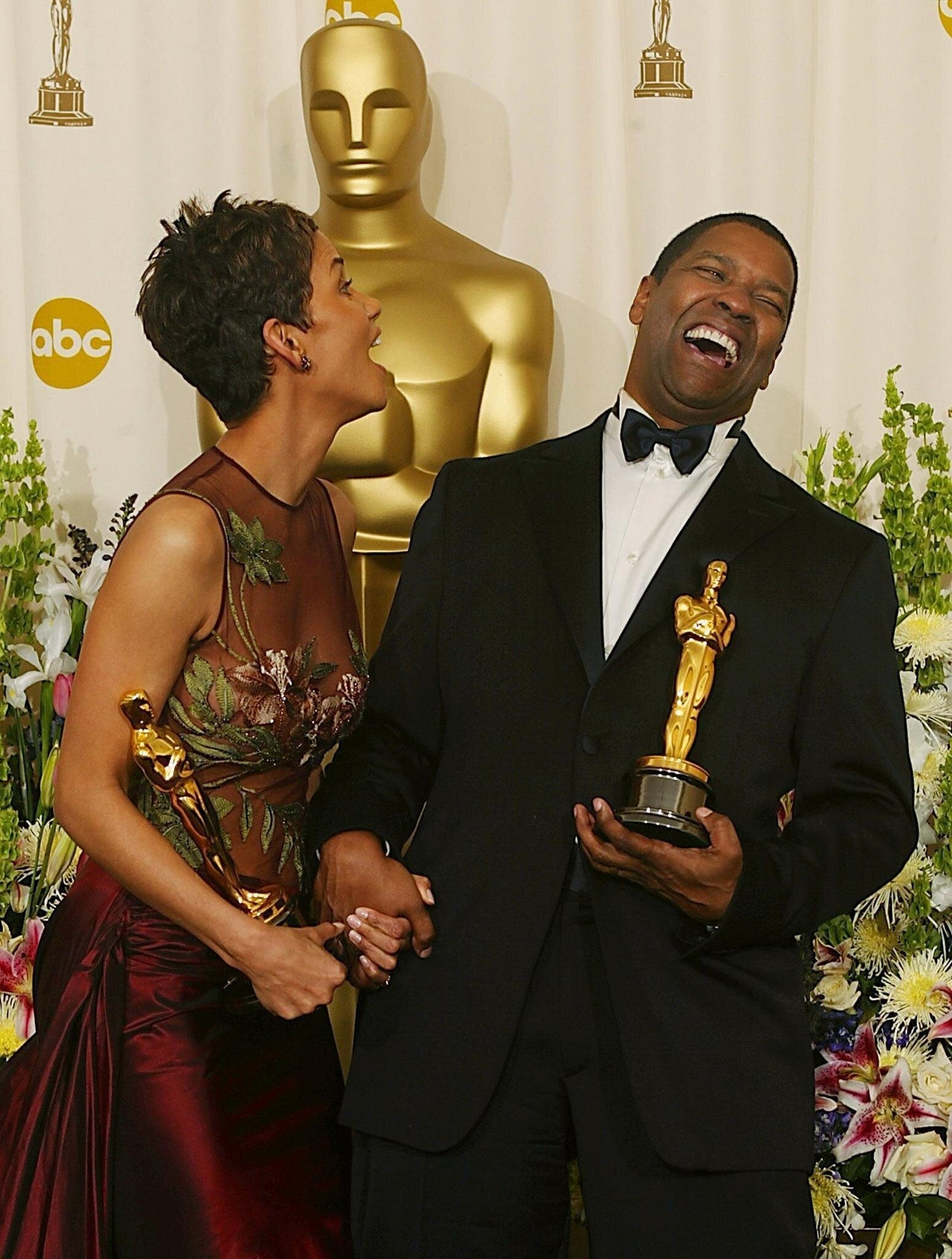 <center><em><small> Denzel Washington and Halle Berry share a laugh while holding their Oscar statues after winning the awards for Best Actor ("Training Day") and Best Actress ("Monster's Ball"), respectively, at the 74th Academy Awards at the Kodak Theater in Hollywood, California. </small></em></center>