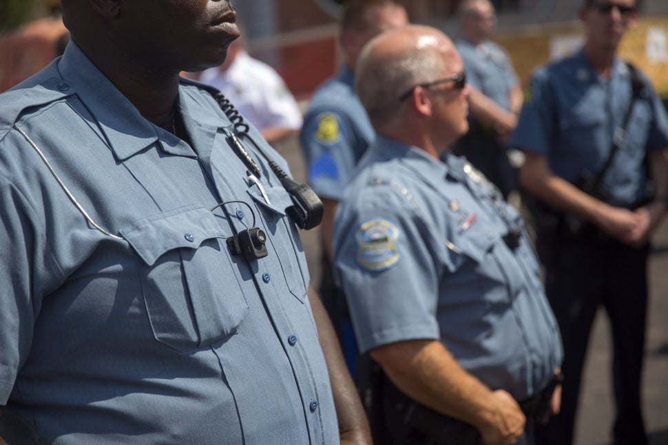 <em>Members of the Ferguson Police Department wear body cameras during a rally on Aug. 30, 2014, in Ferguson, Missouri. Pol