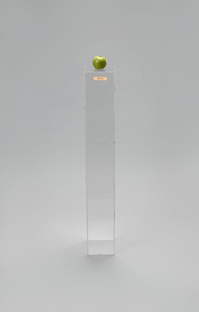 Yoko Ono (Japanese, born 1933) Apple. 1966. Plexiglas pedestal, brass plaque, apple, 45 × 6 11/16 × 6 15/16″ (114.3 × 17 × 17.6 cm). Private collection. © Yoko Ono 2014