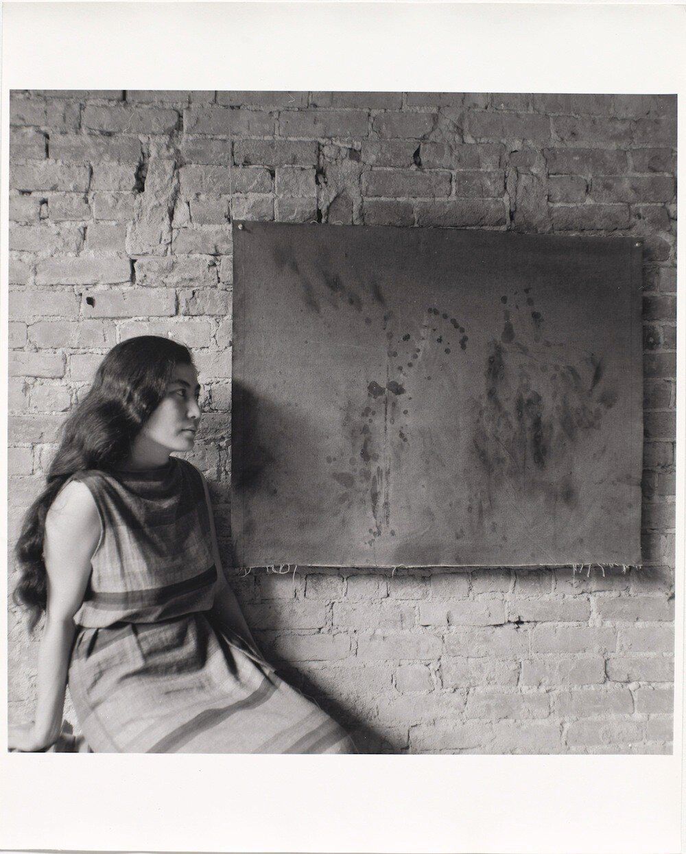 Painting to See in the Dark (Version 1). 1961. Installation view with the artist, Paintings & Drawings by Yoko Ono, AG Gallery, New York, July 17–30, 1961. Photograph by George Maciunas.