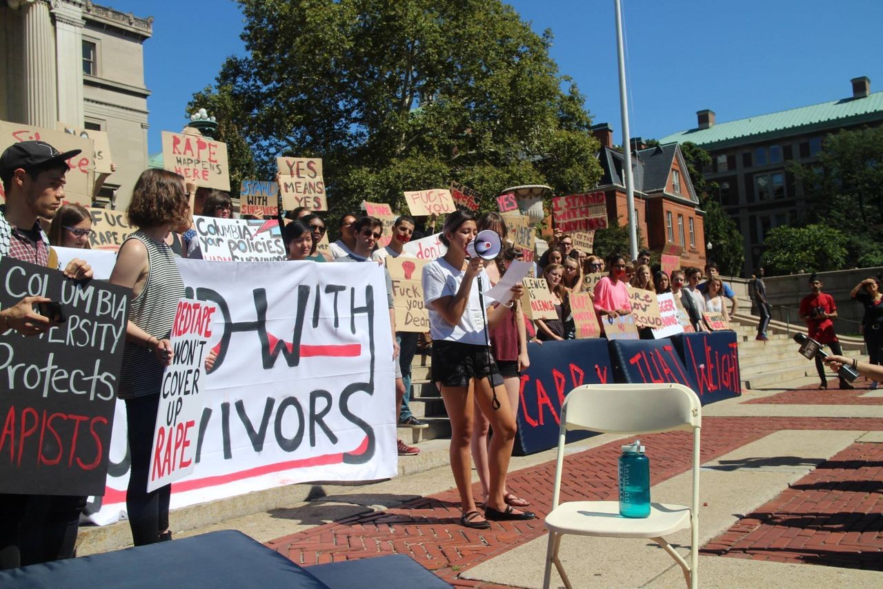 <em>Students, including Emma Sulkowicz, center, protest Columbia University's handling of sexual assault during a fall 2014 demonstration. </em>
