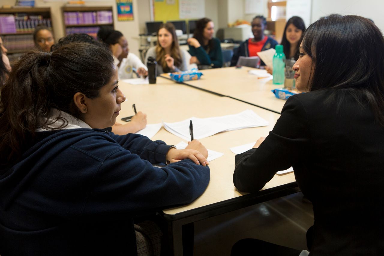 <em>Espinosa (right) speaks with a mentee at The Young Women’s Leadership School of East Harlem.</em>