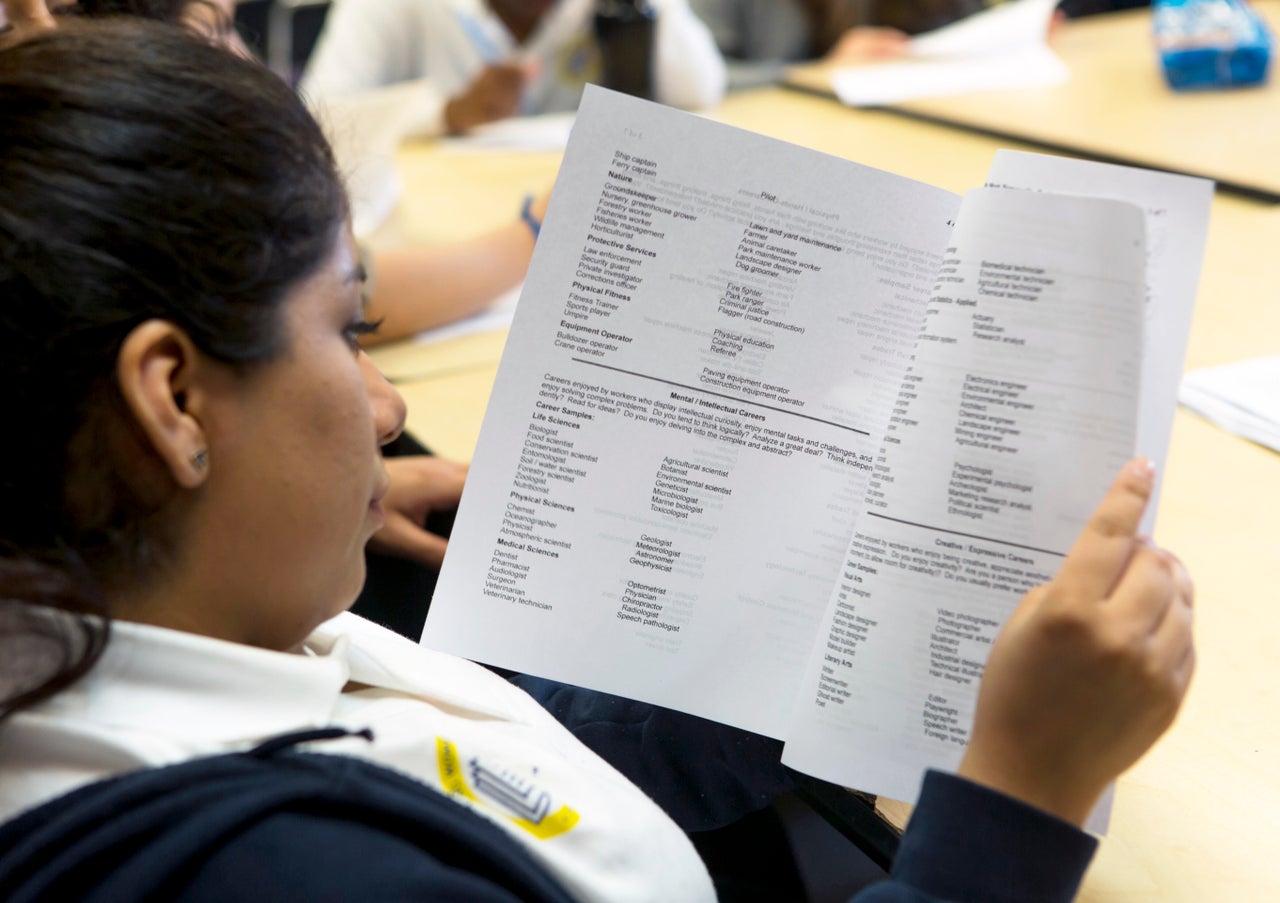 <em>A mentee reviews a handout on college majors and concentrations. </em>