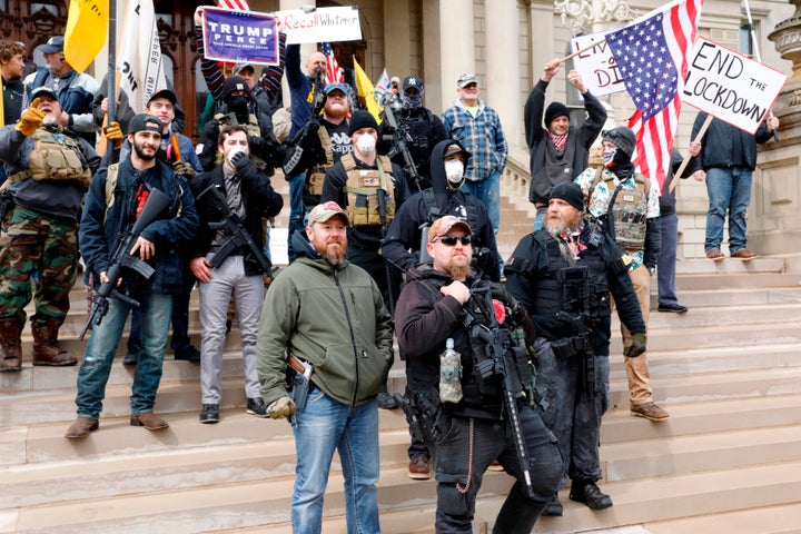 People take part in a protest against Michigan Governor Gretchen Whitmer's stay-at-home order at the Michigan State Capitol in Lansing, Michigan on April 15, 2020. 