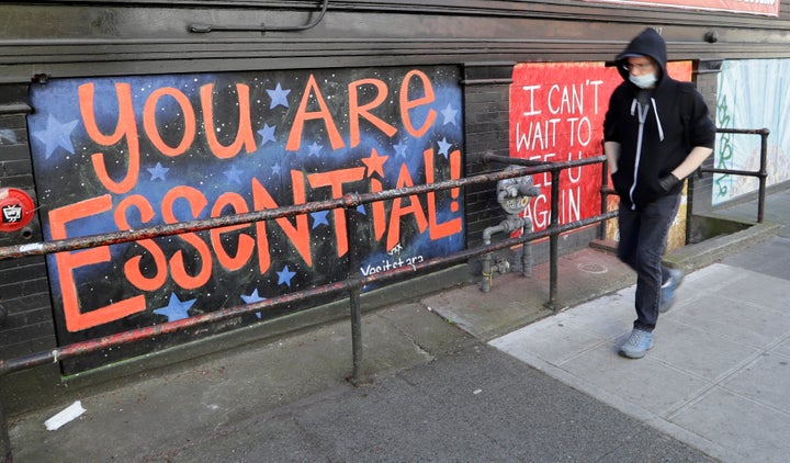 A pedestrian walks past a closed business during the coronavirus outbreak on April 16, 2020, in Seattle. More than 585,000 people in Washington state sought unemployment benefits last week, with 143,000 people filing claims for the first time. 