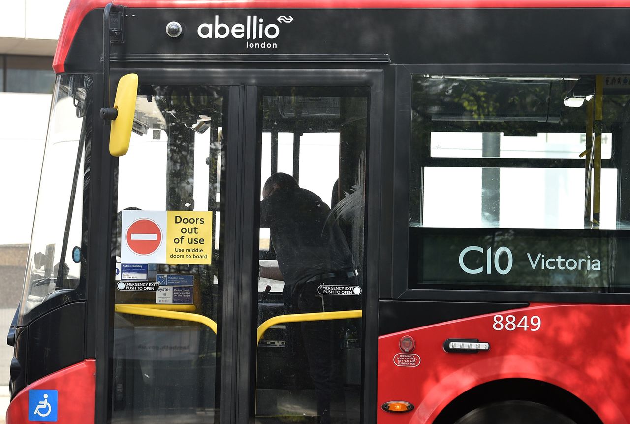 A sign reading "doors out of use" is pictured on the front doors of a Transport for London (TfL) bus.