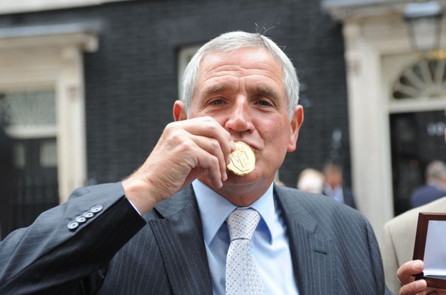 Norman Hunter kisses his medal, presented by Prime Minister Gordon Brown for representing his country in the 1966 World Cup.