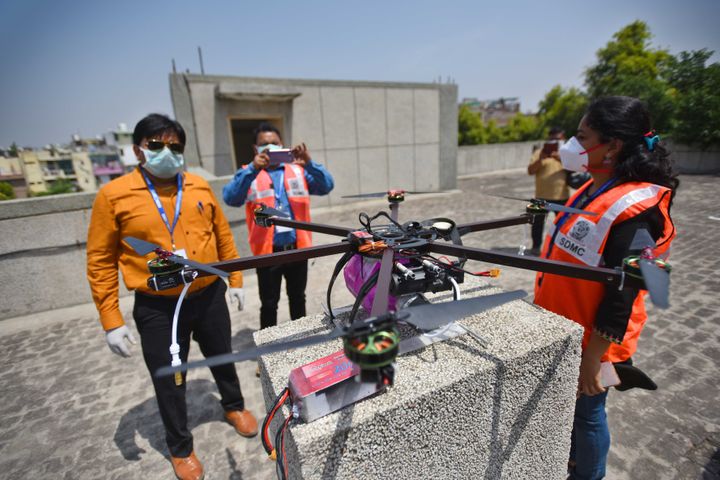 A Municipal Corporation of Delhi (MCD) team prepares a drone during a sanitisation drive in the Hauz Rani Village containment zone, on April 16, 2020 in New Delhi.