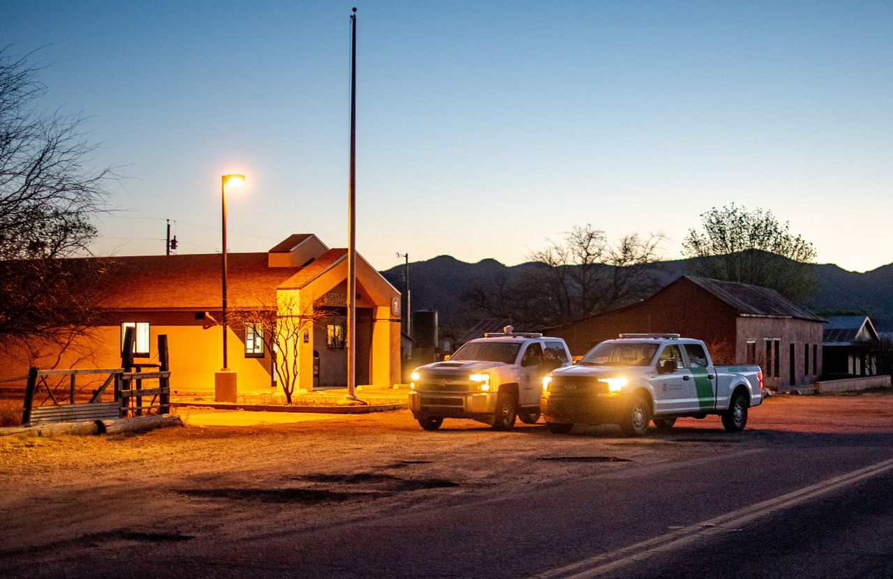 U.S. Border Patrol trucks sit parked on the main road in Arivaca on April 15.