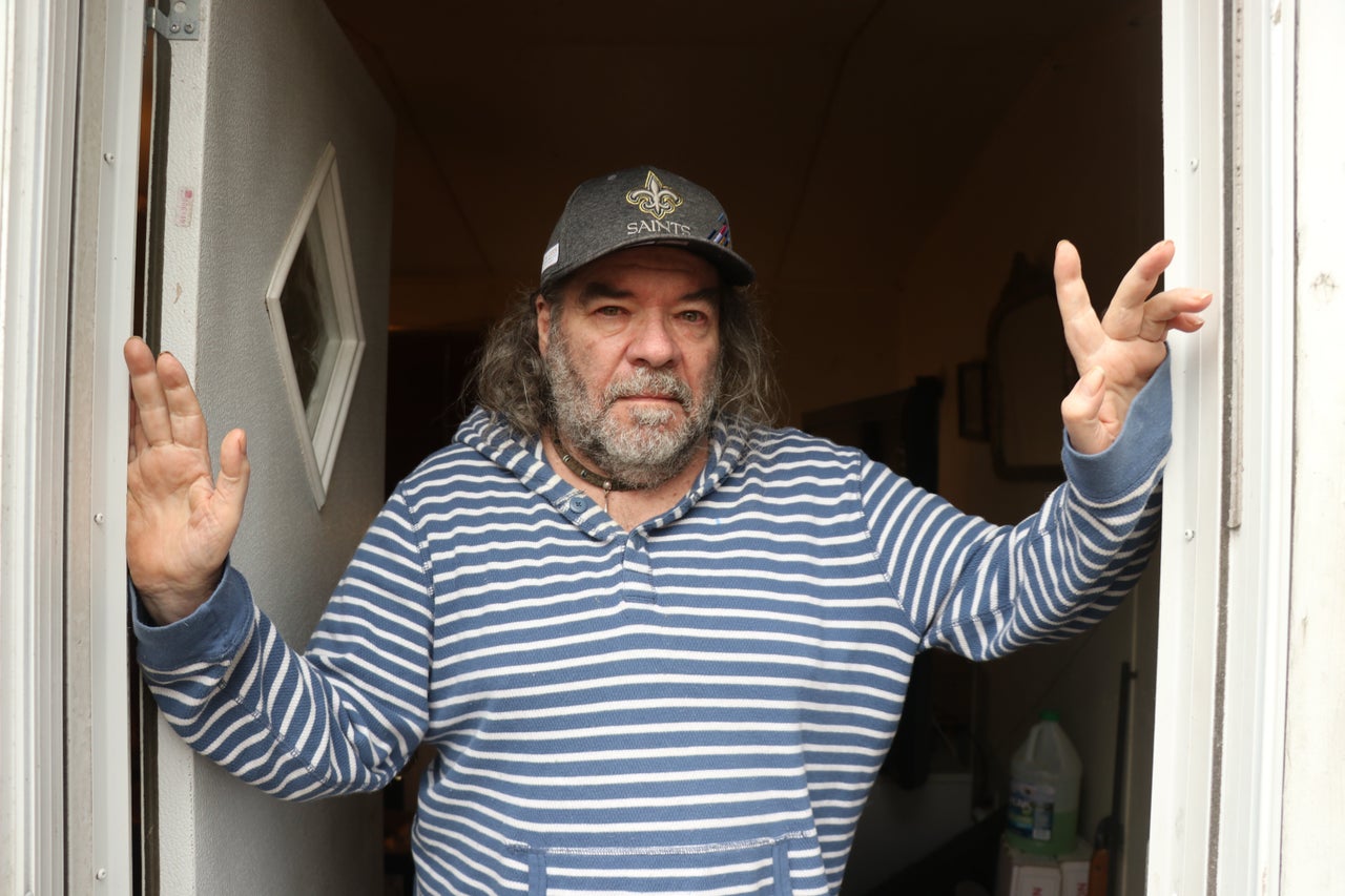 Rick DuFour outside his trailer home that he shares with his 86-year-old father in Moss Point, Mississippi.